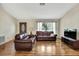 Cozy living room with hardwood floors, large window, and comfortable seating for Gathering and friends at 5042 Gaston St, Spring Hill, FL 34607