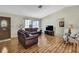 Bright living room featuring wood floors, large windows, and comfortable seating perfect for relaxing at 5042 Gaston St, Spring Hill, FL 34607