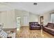 Inviting living room featuring wood floors, neutral paint, and an open layout to the kitchen at 5042 Gaston St, Spring Hill, FL 34607