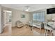 Comfortable living room with wood floors, a glass coffee table, and a ceiling fan at 5042 Gaston St, Spring Hill, FL 34607