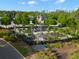 Aerial view of a picturesque community garden with charming windmill and lush, vibrant plantings at 5043 Night Star Trl, Odessa, FL 33556