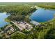 Aerial view of the community, including a large lake, garden area, parking lot and walking paths at 5043 Night Star Trl, Odessa, FL 33556