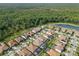 Community aerial view showcasing homes with well-kept lawns, pools, and lush landscaping at 5043 Night Star Trl, Odessa, FL 33556