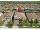 Aerial view of a two-story home with a tile roof, mature landscaping, and an inviting yard at 5043 Night Star Trl, Odessa, FL 33556