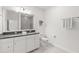 Modern bathroom features double sink vanity, bright lighting, walk-in shower, and white cabinets at 5043 Night Star Trl, Odessa, FL 33556