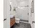Modern bathroom with a glass-enclosed shower, stylish vanity, and hexagon tile floors at 5043 Night Star Trl, Odessa, FL 33556