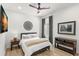 Cozy bedroom features a ceiling fan, window with shutters and curtains, and warm, neutral decor at 5043 Night Star Trl, Odessa, FL 33556