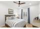 Comfortable bedroom with hardwood floors, ceiling fan, neutral walls, and lots of natural light at 5043 Night Star Trl, Odessa, FL 33556