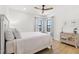 Well-lit bedroom featuring hardwood floors, neutral walls, ceiling fan, and two windows for natural light at 5043 Night Star Trl, Odessa, FL 33556
