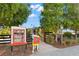 Cute community book share with accessible sign, and landscaping at 5043 Night Star Trl, Odessa, FL 33556