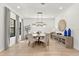Bright dining room featuring a round table, stylish chairs, and modern light fixture at 5043 Night Star Trl, Odessa, FL 33556
