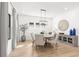 Bright dining room featuring a round table, stylish chairs, and modern light fixture at 5043 Night Star Trl, Odessa, FL 33556