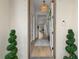 View from the front door into the foyer and hallway with a decorative light fixture overhead at 5043 Night Star Trl, Odessa, FL 33556