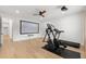 Home theater and workout room features an elliptical, treadmill, projection screen, and ceiling fan at 5043 Night Star Trl, Odessa, FL 33556