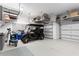 Spacious garage with golf cart, storage racks, and functional organization system at 5043 Night Star Trl, Odessa, FL 33556