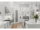 Spacious kitchen with white cabinets, stainless steel appliances, large island, and wood floors at 5043 Night Star Trl, Odessa, FL 33556