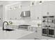 Close up of a modern kitchen with white cabinets, stainless steel appliances, and a large island at 5043 Night Star Trl, Odessa, FL 33556