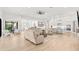 Bright and airy living area with hardwood floors and views of the outdoor dining area at 5043 Night Star Trl, Odessa, FL 33556