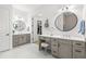 Dual vanity bathroom featuring modern fixtures, walk-in closet, and bright lighting at 5043 Night Star Trl, Odessa, FL 33556