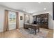 Sunlit home office features hardwood floors, large windows, built-in bookcase, and a comfortable workspace at 5043 Night Star Trl, Odessa, FL 33556