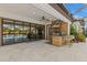 Outdoor kitchen featuring a built-in grill, bar seating, and seamless access to the interior at 5043 Night Star Trl, Odessa, FL 33556