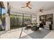 Relaxing screened patio with comfortable seating, ceiling fans, and a mounted television at 5043 Night Star Trl, Odessa, FL 33556