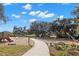 Community playground with slides, swings, and climbing structures, surrounded by mature trees at 5043 Night Star Trl, Odessa, FL 33556