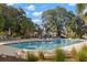 Community pool with ample lounge seating and lush landscaping creates a resort-style experience at 5043 Night Star Trl, Odessa, FL 33556