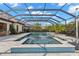 Enclosed pool and spa offering a serene outdoor retreat with mature landscaping at 5043 Night Star Trl, Odessa, FL 33556