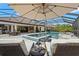 Covered patio features a luxurious pool, spa, outdoor seating, bar, and lounging area at 5043 Night Star Trl, Odessa, FL 33556