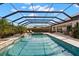 Spacious pool and spa with a screened enclosure, complete with outdoor seating at 5043 Night Star Trl, Odessa, FL 33556