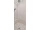 Walk-in shower featuring tiled walls, a built-in bench, and modern fixtures at 5043 Night Star Trl, Odessa, FL 33556