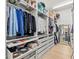 Spacious walk-in closet with custom shelving, drawers, and ample storage space at 5043 Night Star Trl, Odessa, FL 33556