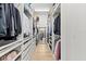Spacious walk-in closet with custom shelving and drawers, offering ample storage and organization at 5043 Night Star Trl, Odessa, FL 33556