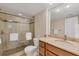 Well-lit bathroom with a glass shower and marble countertops at 5855 Midnight Pass Rd # 201, Sarasota, FL 34242
