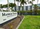 Harbor Towers Yacht & Racquet Club community sign near the meticulously landscaped grounds at 5855 Midnight Pass Rd # 201, Sarasota, FL 34242