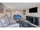 The living room features stylish furnishings, tile flooring, and large windows that let in plenty of natural light at 5855 Midnight Pass Rd # 201, Sarasota, FL 34242