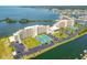 Aerial view of waterfront community with condos, tennis courts, parking, and boat docks at 6009 Sea Ranch Dr # 107E, Hudson, FL 34667