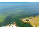 Waterfront property with a pier, a sandy beach, and lush greenery at 6009 Sea Ranch Dr # 107E, Hudson, FL 34667