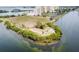 Aerial view of a waterfront property with lush landscaping and access to the water at 6009 Sea Ranch Dr # 107E, Hudson, FL 34667