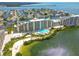 Expansive aerial view of condo complex with a pool, beach, and waterfront access on a sunny day at 6009 Sea Ranch Dr # 107E, Hudson, FL 34667