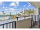 Balcony seating area provides a picturesque setting with views of the beach, pool, palm trees, and blue skies at 6009 Sea Ranch Dr # 107E, Hudson, FL 34667
