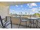 Relax on the balcony with views of the pool, beach, and clear blue sky with light and airy clouds at 6009 Sea Ranch Dr # 107E, Hudson, FL 34667