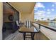 Balcony with table and chairs overlooks the pool and beach for an enjoyable outdoor living experience at 6009 Sea Ranch Dr # 107E, Hudson, FL 34667