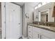 Bright bathroom with white cabinets, granite counters and a shower at 6009 Sea Ranch Dr # 107E, Hudson, FL 34667