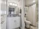 Bright bathroom with white vanity, decorative mirror, and shower/tub with tiled walls and modern fixtures at 6009 Sea Ranch Dr # 107E, Hudson, FL 34667