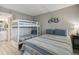 Comfortable bedroom featuring a bunk bed, twin bed, and stylish decor with wood look floors at 6009 Sea Ranch Dr # 107E, Hudson, FL 34667