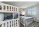 Cozy bedroom with bunk beds, a twin bed, and a window with natural light and bright linens at 6009 Sea Ranch Dr # 107E, Hudson, FL 34667