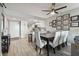 Dining area flows into a modern kitchen with stainless steel appliances and island at 6009 Sea Ranch Dr # 107E, Hudson, FL 34667