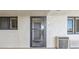 Condo entrance featuring neutral colors, a glass door and windows on either side at 6009 Sea Ranch Dr # 107E, Hudson, FL 34667